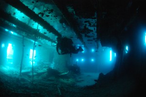 diver glides through the superstructure of the Thistlegorm